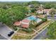 Aerial view of a pool surrounded by trees, landscaping, and condo units at 3505 Tarpon Woods Blvd # K409, Palm Harbor, FL 34685