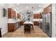 Modern kitchen featuring stainless steel appliances, a large island, and wood cabinets at 375 5Th N Ave, Safety Harbor, FL 34695