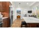 Modern kitchen with large island, stainless steel refrigerator, and adjacent dining area at 375 5Th N Ave, Safety Harbor, FL 34695