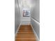 Staircase with wood treads and white risers leading to upper level, lit by modern chandelier at 375 5Th N Ave, Safety Harbor, FL 34695