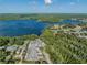 Expansive aerial view showcasing the serene lake and surrounding lush greenery at 3956 Tarpon Pointe Cir, Palm Harbor, FL 34684