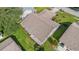 Aerial view of a well-maintained single-story home with a manicured lawn and screened porch at 3956 Tarpon Pointe Cir, Palm Harbor, FL 34684