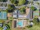 Aerial view showcasing a pool, tennis courts, and well-maintained clubhouse for the community at 3956 Tarpon Pointe Cir, Palm Harbor, FL 34684