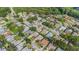 Aerial view of the neighborhood features mature trees, houses and street at 3956 Tarpon Pointe Cir, Palm Harbor, FL 34684