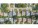 Aerial view of a neighborhood displaying several houses with mature trees and green lawns at 3956 Tarpon Pointe Cir, Palm Harbor, FL 34684