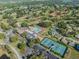 Expansive aerial view displaying community pool, tennis courts, and lush landscaping at 3956 Tarpon Pointe Cir, Palm Harbor, FL 34684