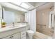 Relaxing bathroom with a shower and tub combo, tile surround and a modern vanity at 3956 Tarpon Pointe Cir, Palm Harbor, FL 34684