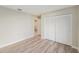 This bedroom offers wood-look floors, neutral walls and double closets at 3956 Tarpon Pointe Cir, Palm Harbor, FL 34684