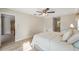 Comfortable bedroom features a ceiling fan, neutral walls and wood-look flooring at 3956 Tarpon Pointe Cir, Palm Harbor, FL 34684