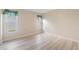 Bedroom features neutral walls, wood-look flooring and bright windows at 3956 Tarpon Pointe Cir, Palm Harbor, FL 34684