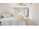 Bright bedroom features a ceiling fan, neutral walls and wood-look flooring at 3956 Tarpon Pointe Cir, Palm Harbor, FL 34684