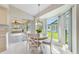 Charming breakfast nook with bright bay windows, pendant lighting, and sliding doors to the lanai at 3956 Tarpon Pointe Cir, Palm Harbor, FL 34684