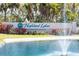 Highland Lakes active adult community sign near a pond with a fountain and landscaping at 3956 Tarpon Pointe Cir, Palm Harbor, FL 34684