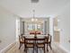 Bright dining room featuring light wood floors and a sliding glass door to the lanai at 3956 Tarpon Pointe Cir, Palm Harbor, FL 34684