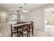 Open dining room with wood floors, views to the front living room and hallway leading to a bedroom at 3956 Tarpon Pointe Cir, Palm Harbor, FL 34684