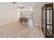 Spacious dining area with wood-look flooring, ceiling fan, and a view of the screened lanai at 3956 Tarpon Pointe Cir, Palm Harbor, FL 34684