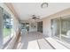 This Florida room has lots of natural light, tile flooring, a bar and access to the outside at 3956 Tarpon Pointe Cir, Palm Harbor, FL 34684