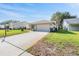 Charming single-story home boasting a well-kept lawn and an attached two-car garage at 3956 Tarpon Pointe Cir, Palm Harbor, FL 34684