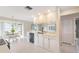 Kitchen with white cabinets, double sink, neutral counters, dishwasher, and view into the breakfast nook at 3956 Tarpon Pointe Cir, Palm Harbor, FL 34684