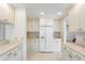 Bright kitchen featuring ample counter space, white cabinets, and tile flooring at 3956 Tarpon Pointe Cir, Palm Harbor, FL 34684