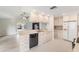 Updated kitchen with white cabinets, neutral counters, tile floors, and stainless steel appliances at 3956 Tarpon Pointe Cir, Palm Harbor, FL 34684