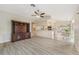 Open living room featuring wood floors, high ceilings, and a view of the kitchen and breakfast nook at 3956 Tarpon Pointe Cir, Palm Harbor, FL 34684