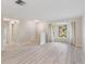 Open living area with modern flooring, neutral walls, and a large bay window offering natural light at 3956 Tarpon Pointe Cir, Palm Harbor, FL 34684