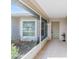 Inviting screened-in porch with tile flooring and views of lush landscaping and a garden at 3956 Tarpon Pointe Cir, Palm Harbor, FL 34684