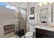 Bathroom featuring a tiled shower with glass door, vanity with granite countertop, and a coordinated neutral color scheme at 4195 Barletta Ct, Wesley Chapel, FL 33543