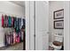 Open closet and bathroom area with ample storage space and linen closet at 4195 Barletta Ct, Wesley Chapel, FL 33543