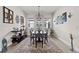 Bright dining room with an elegant chandelier, large windows, and a decorative rug adding a touch of sophistication at 4195 Barletta Ct, Wesley Chapel, FL 33543