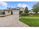 Beautiful two-story home with stone accents, a three-car garage, and manicured landscaping at 4195 Barletta Ct, Wesley Chapel, FL 33543