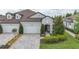 Charming two-story home with stone accents, a three-car garage, and a beautifully landscaped yard at 4195 Barletta Ct, Wesley Chapel, FL 33543
