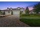 Beautiful exterior view of home with stone accents, three-car garage, and a well-maintained lawn at 4195 Barletta Ct, Wesley Chapel, FL 33543