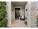 Charming front porch with stone accents, flower decor, and covered entrance at 4195 Barletta Ct, Wesley Chapel, FL 33543