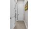 Hallway with a neutral color palette, tiled floor, and door leading to other areas of the home at 4195 Barletta Ct, Wesley Chapel, FL 33543