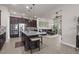 Open concept kitchen with stainless steel appliances, granite countertops, a central island, and seamless connection to the living area at 4195 Barletta Ct, Wesley Chapel, FL 33543