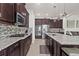 Spacious kitchen featuring stainless steel appliances, granite countertops, tile backsplash, and a convenient center island at 4195 Barletta Ct, Wesley Chapel, FL 33543