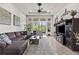 Spacious living room with high ceilings, large windows, ceiling fan, and comfortable seating at 4195 Barletta Ct, Wesley Chapel, FL 33543
