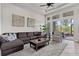 Comfortable living room with a sectional sofa, area rug, and a large window offering natural light and outdoor views at 4195 Barletta Ct, Wesley Chapel, FL 33543