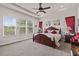 Spacious main bedroom features tray ceilings, carpet floors, and large windows for natural light at 4195 Barletta Ct, Wesley Chapel, FL 33543