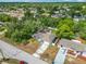 Aerial view of a single-Gathering home with a driveway, surrounded by lush green trees at 4435 Lamson Ave, Spring Hill, FL 34608