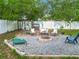 Landscaped backyard featuring a fire pit, mature trees, and a chicken coop at 4435 Lamson Ave, Spring Hill, FL 34608