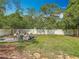 Spacious backyard featuring a lush lawn and mature trees at 4435 Lamson Ave, Spring Hill, FL 34608