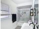 Bathroom featuring a shower with glass doors, a sink, and a mirror at 4435 Lamson Ave, Spring Hill, FL 34608