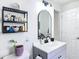Bathroom with a modern vanity and sink, decorative mirror, and shelving at 4435 Lamson Ave, Spring Hill, FL 34608