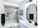 Bathroom featuring a shower with glass doors, a sink, and a mirror at 4435 Lamson Ave, Spring Hill, FL 34608