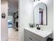 Bathroom featuring a sleek vanity with granite counters and an arched mirror at 4435 Lamson Ave, Spring Hill, FL 34608