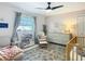 Charming Bedroom with a rocker, changing table, and soft colors at 4435 Lamson Ave, Spring Hill, FL 34608