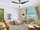 Inviting Bedroom featuring a cozy chair, crib, and stylish decor at 4435 Lamson Ave, Spring Hill, FL 34608